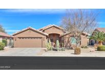 Charming single-story home featuring desert landscaping, a two-car garage, and a welcoming entrance at 2408 E Fiesta Dr, Casa Grande, AZ 85194