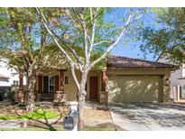 Charming single-story home with a well-manicured lawn, two-car garage and inviting front porch with wooden pillars at 3540 E Morrison Ranch Pkwy, Gilbert, AZ 85296
