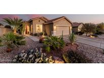 Southwest home exterior showcasing desert landscaping and a two-car garage, enhancing its curb appeal at 537 S 225Th Ave, Buckeye, AZ 85326