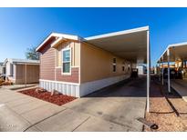 Tan and brown single-story home featuring covered parking and manicured landscaping at 806 W Summerside Rd, Phoenix, AZ 85041