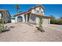 Charming two-story home featuring a well-maintained yard and desert landscaping at 1202 W Sand Hills Ct, Gilbert, AZ 85233