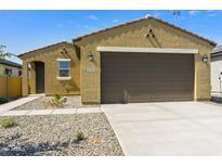 Charming single-story home featuring a two-car garage, desert landscaping, and a covered front entry at 12738 N 172Nd Dr, Surprise, AZ 85388