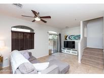 Bright living room with neutral tones, tiled flooring, and sliding door to the backyard at 1350 S Greenfield Rd # 1016, Mesa, AZ 85206