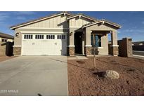 Charming single-story home with a two-car garage and well-maintained front yard, showcasing modern design and curb appeal at 17434 W Las Palmaritas Dr, Waddell, AZ 85355