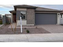 Charming single-story home featuring a brick and stucco facade and a two-car garage at 18254 W Vogel Ave, Goodyear, AZ 85338