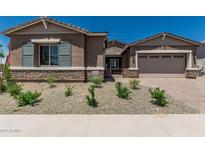 Charming single-story home featuring a two-car garage, desert landscaping, and a welcoming entrance at 20624 S 216Th Pl, Queen Creek, AZ 85142