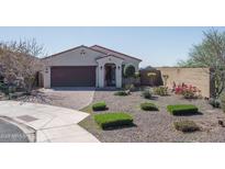 Charming single-story home featuring a low-maintenance desert landscape and a welcoming front entrance at 21427 W Monte Vista Rd, Buckeye, AZ 85396