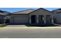 Charming single-story home with a covered porch and neutral color palette at 10027 W Verde Ln, Avondale, AZ 85392