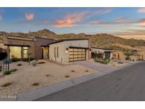 Stunning single-story home with a modern design, desert landscaping, and a backdrop of picturesque mountain views at 14715 N Adero Canyon Dr, Fountain Hills, AZ 85268