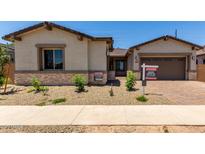 Charming single-story home with desert landscaping, a brick driveway, and a two-car garage at 20570 S 216Th Pl, Queen Creek, AZ 85142