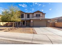 Inviting two-story home with a well-maintained yard and an attached two-car garage at 25589 W Pleasant Ln, Buckeye, AZ 85326