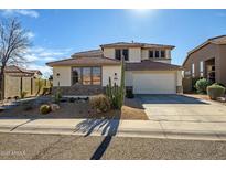 Charming two-story home with desert landscaping, a two-car garage, and a welcoming facade on a sunny day at 2829 W Haley Dr, Anthem, AZ 85086