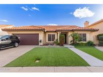 Charming single-story home featuring a red tile roof, green artificial lawn, and desert landscaping at 607 W Palo Verde St, Gilbert, AZ 85233