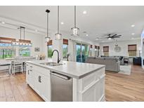 Spacious kitchen with island, stainless dishwasher, and views of the living and dining areas at 11241 N Blakely St, Surprise, AZ 85388