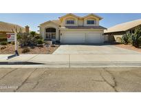 Charming two-story home featuring a three-car garage, well-maintained landscaping, and a welcoming entrance at 12403 W Monte Vista Rd Rd, Avondale, AZ 85392