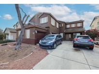 Two-story home featuring a two car garage, shutters, and easy to maintain landscaping at 17641 W Corrine Dr, Surprise, AZ 85388