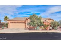 Charming home featuring a two-car garage and desert landscaping at 19973 N Monte Ln, Maricopa, AZ 85138