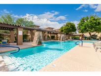Stunning community pool area features waterfalls, lounge chairs, and meticulously maintained landscaping at 20100 N 78Th Pl # 2210, Scottsdale, AZ 85255