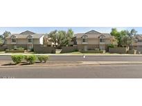 Inviting two-story townhomes with neutral exterior and lush greenery along a street at 2035 S Elm St # 114, Tempe, AZ 85282