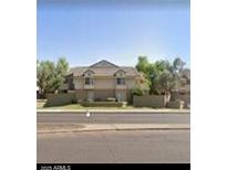 Inviting two-story home featuring a well-maintained lawn, mature trees, and a classic design at 2035 S Elm St # 114, Tempe, AZ 85282