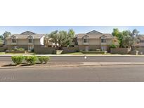 Beige two-story apartments with well-maintained landscaping and private patios in a quiet residential neighborhood at 2035 S Elm St # 114, Tempe, AZ 85282