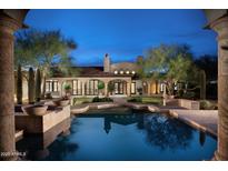 Stunning backyard view featuring a private pool reflecting the architecture of this luxury estate at 23779 N 91St St, Scottsdale, AZ 85255