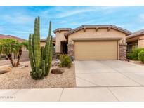 Charming home with desert landscaping, beautiful stucco, and a two car garage at 32177 N Echo Canyon Rd, San Tan Valley, AZ 85143