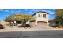 Charming two-story home featuring a two-car garage, desert landscaping, and an inviting covered porch at 5924 W Running Deer Trl, Phoenix, AZ 85083