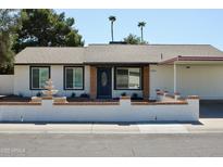 Charming single-story home features a well-manicured front yard with a lovely fountain at 9019 W Griswold Rd, Peoria, AZ 85345