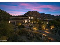 Beautiful exterior view of modern home with three-car garage, desert landscaping, and mountain views at 10585 E Crescent Moon Dr # 44, Scottsdale, AZ 85262