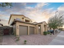 Inviting home with a two-car garage, covered entryway, and low-maintenance desert landscaping at 14257 W Harvard St, Goodyear, AZ 85395
