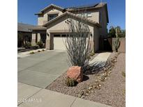 Charming two-story home featuring a desert-landscaped front yard and a two-car garage at 15266 N 146Th Ln, Surprise, AZ 85379