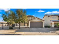 Charming single Gathering home with a two-car garage, desert landscaping, and neutral tones at 16207 W Moreland St, Goodyear, AZ 85338