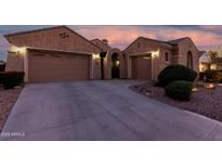 Inviting home featuring a two-car garage, desert landscaping, and an arched entryway at 2089 E Lynx Pl, Chandler, AZ 85249