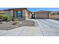 Charming single-story home with a two-car garage, desert landscaping and a neutral color palette at 25951 N 106Th Dr, Peoria, AZ 85383