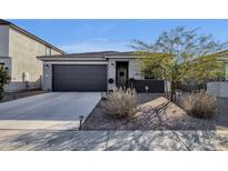 Charming single story home with a two car garage, landscaped yard, and cozy front entrance at 36243 W San Clemente Ave, Maricopa, AZ 85138