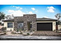 Striking single-story home showcasing stone accents, a paved driveway, and a two-car garage at 3634 W Mineral Rd, Laveen, AZ 85339