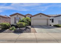 Charming home with a two car garage, desert landscaping, and a brick paver walkway at 4483 E Sourwood Dr, Gilbert, AZ 85298