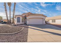 Charming single Gathering home with desert landscaping and attached two car garage at 5125 W Wikieup Ln, Glendale, AZ 85308