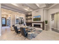 Spacious living room features coffered ceilings, fireplace, and seamless indoor-outdoor living at 5421 E Juniper Canyon Dr, Cave Creek, AZ 85331