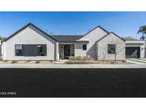 Modern exterior with white stucco and brick accents, dark trim, and meticulous landscaping at 6313 N 10Th Dr, Phoenix, AZ 85013