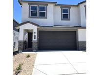 Charming two-story home featuring a 2-car garage, covered entry, and a mix of stone and stucco exterior at 9831 S 11Th St, Phoenix, AZ 85042