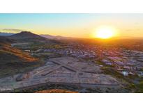 Breathtaking aerial view showcasing the community, desert landscape, and a stunning sunrise at 9831 S 11Th St, Phoenix, AZ 85042