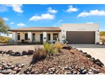 Charming single-story home with a brown tile roof and a two-car garage, surrounded by desert landscaping at 17037 E El Pueblo Blvd, Fountain Hills, AZ 85268