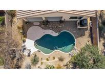 Aerial view of a private pool, with desert landscaping, and rock waterfall feature at 17560 W Desert View Ln, Goodyear, AZ 85338