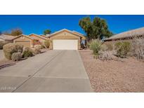 Single-story home featuring a two-car garage and desert landscaping at 2106 E 39Th Ave, Apache Junction, AZ 85119