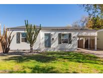 Charming single-story home with a well-maintained lawn and desert landscaping at 2219 N 13Th St, Phoenix, AZ 85006