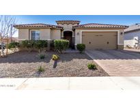 Charming single-story home featuring a well-manicured desert landscape and a private two-car garage at 25913 W Sands Dr, Buckeye, AZ 85396