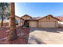 Charming single-story home with a three-car garage and desert landscaping at 2716 N Kristen --, Mesa, AZ 85213