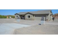 Stunning single-story home showcasing a spacious driveway and desert surroundings at 27227 N 147Th Ave, Surprise, AZ 85387